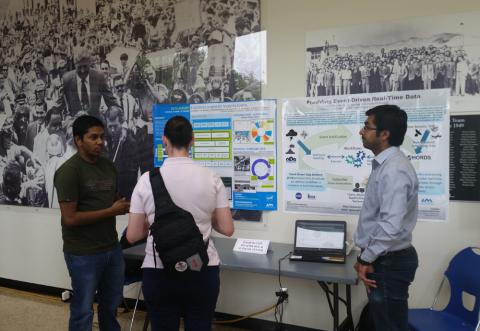 ITSC students Sandip Sahani and Sumeet Kore in front of ITSC DataAlbums and ED3/CHORDS posters