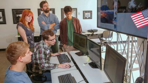 Earth System Science graduate students Tyler Finley and Tim Klug and undergraduate students Olivia Buchanan and Ankur Shah work with Dr. Rob Griffin on the Sally Ride EarthKAM project at the U.S. Space & Rocket Center. Photo by Michael Mercier | UAH