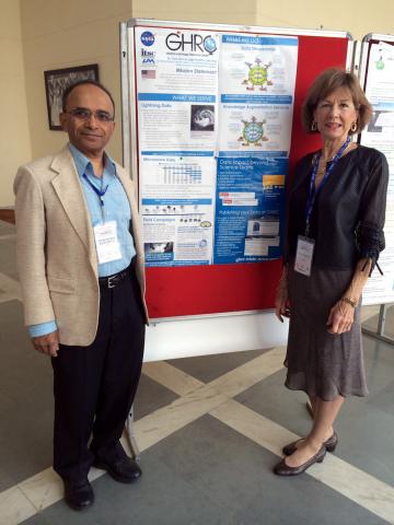 Hampapuram Ramapriyan and Sara Graves stand in front of the GHRC poster at SciDataCon 2014.